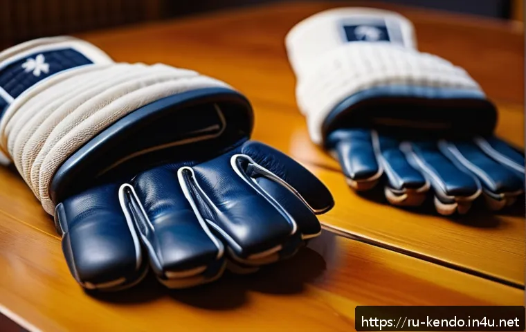검도 장갑 종류와 선택법 - A close-up image of a pair of kendo gloves displayed on a wooden surface, showcasing the contrast be...